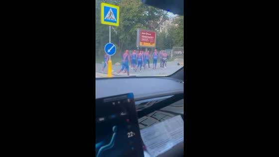 Group of people dressed as Spider-Man crosses a street in Moscow, Russia
