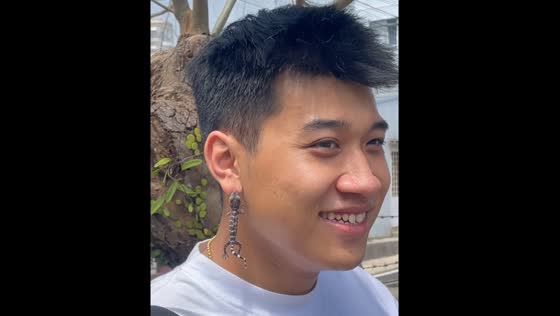 Lizard hangs from person's earlobe like an earring in Vietnam