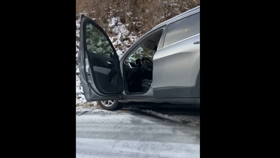 Car slides off icy road in Gatlinburg as person expresses longing for summer