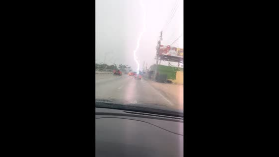 Lightning strikes power line beside highway during storm in Miami, USA