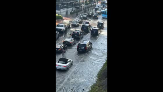 King tide floods Miami Beach streets as cars navigate submerged roads in Florida, USA