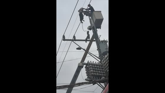 Emergency responders rescue man from electric post in Manila, Philippines