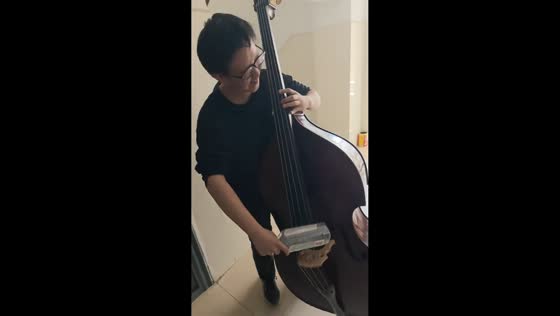 Man plays double bass using an empty bottle in Hebei, China