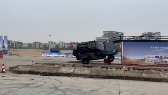Off-road car flips after hitting ramp during city racing event in Hubei, China