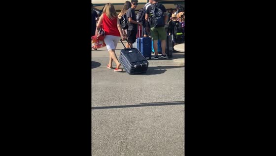 Person pulls suitcase upside down in Naples, Italy
