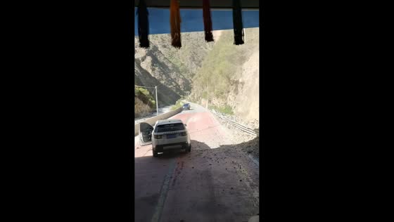 Motorists take cover after rockfall on Sichuan-Tibet Highway in China