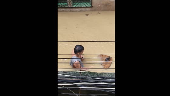 Man saves rat during typhoon Gaemi flood in Pasig, Metro Manila