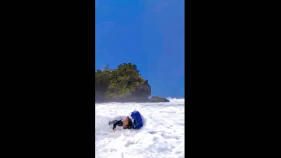 Waves of laughter: spontaneous joy amidst the turbulence at Pantai Madasari Beach