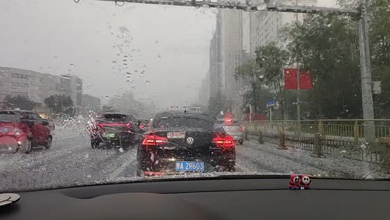 Hailstorm turns busy roadway white as vehicles drive through severe weather in Inner Mongolia, China