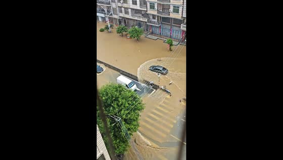 Sedan drives through flooded street during Typhoon Saudel in Fujian, China