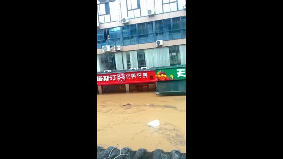 Muddy floodwater inundates commercial street and shops in Fujian, China