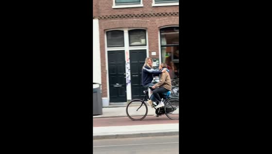 Couple spotted riding bicycle in a unique way in Amsterdam, Netherlands