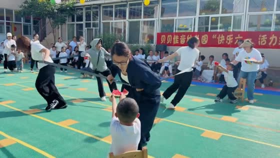 Parents play elastic-band watermelon game during Children’s Day in Hebei, China