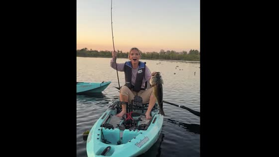 Woman fishing on a boat catches a big fish in Parrish, Florida