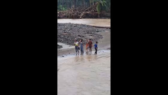 Teachers brave deep floodwaters on the way to remote villages in Leyte, Philippines