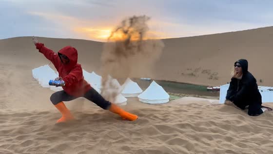 Friends create dramatic desert photo shoot with flying sand in Liaoning, China
