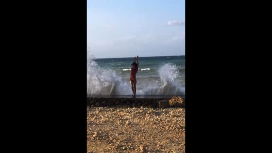 Boy amusingly “controls” ocean waves in Aloguinsan, Cebu, Philippines
