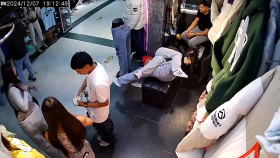 Two girls fall off a bench while play wrestling in Bogotá, Colombia