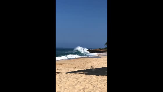 Surfer tumbles off board after big wave in Oahu, Hawaii, USA