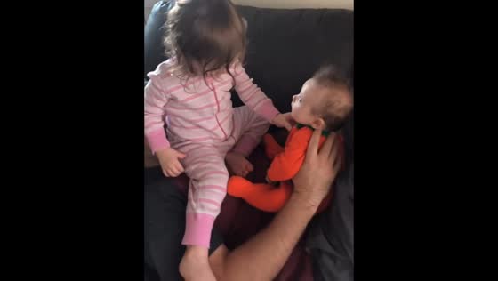 Siblings playfully climb and bond atop their father in Colorado, USA