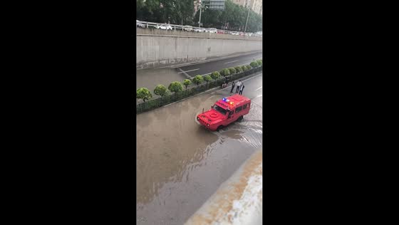 Emergency rescue vehicle drives through flooded road in Shanxi, China
