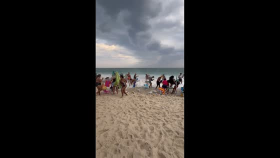 Strong winds and rough waves hit crowded beach in Rio de Janeiro, Brazil