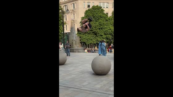 Man showcases agility with parkour jumps and flip in Victoria Square, Birmingham, UK