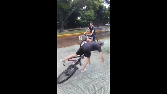 Boy slips during bicycle ride on rainy bike lane in Caracas, Venezuela
