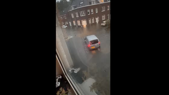 Torrential rain turns Maastricht streets into rivers: cars wading through tire-high floodwaters