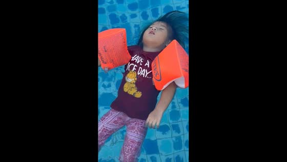 Toddler floats peacefully in pool in Lapu-Lapu, Cebu, Philippines