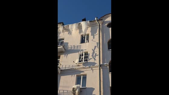 Icicle removal mishap damages air conditioner on snowy roof in Minsk, Belarus