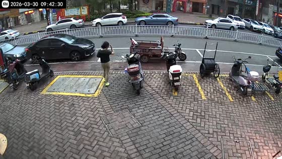 Woman stops tricycle pushed by strong winds in Guangdong, China