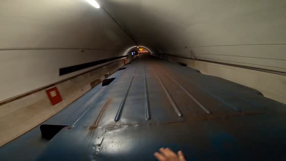 Man crosses train cars while moving in St. Petersburg, Russia