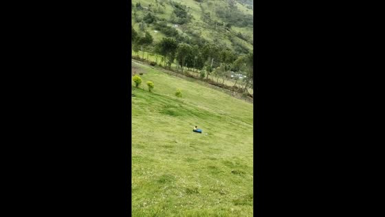 Child slides downhill on DIY drum canoe in Toribio, Cauca