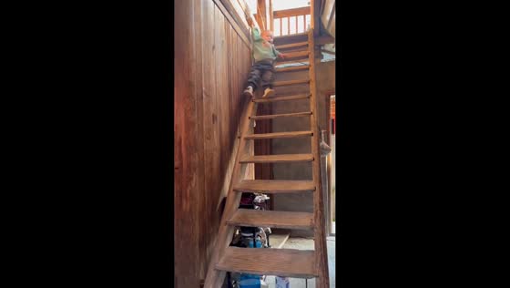 Toddler carefully bounces down stairs in Shanghai, China