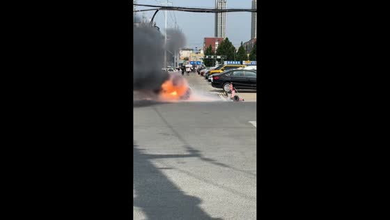 High-voltage wire sparks on road, people keep distance in Guangdong, China