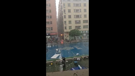 Typhoon winds send food cart sliding across basketball court in Guangdong, China
