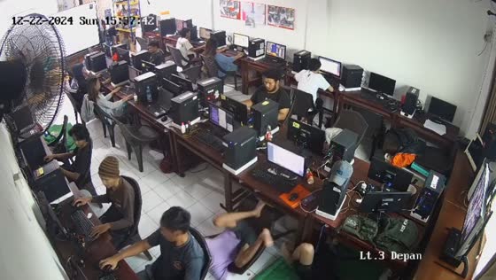 Guy falls off chair while gaming at internet cafe in Bandung, Indonesia