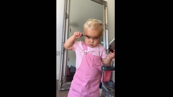 Child does eyebrow makeup using mom's products in Bracknell, United Kingdom