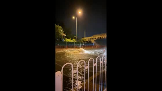 Powerful surge of floodwater blocks roadway in Taiyuan, China