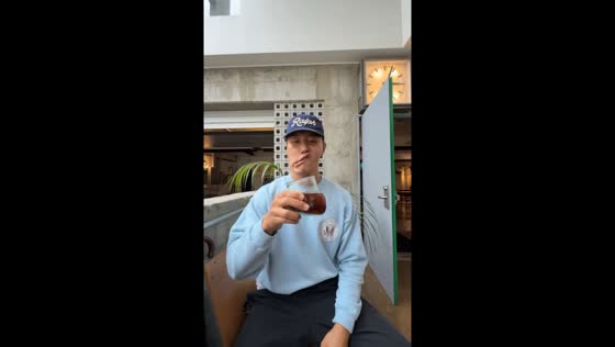 Person tries to drink from a slanted glass at Seoul's CCCS Salon