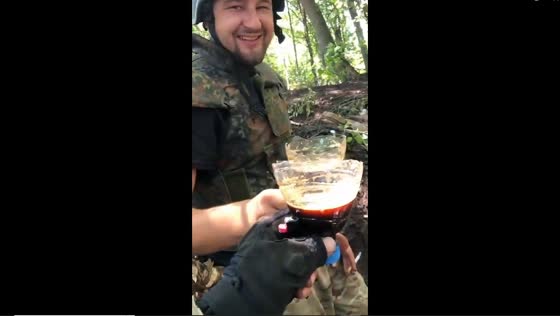 Ukrainian forces find respite amidst conflict by having a drink in makeshift plastic bottle cups
