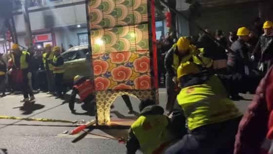 Performer collapses during traditional dragon lantern procession in Weishan, Yunnan, China
