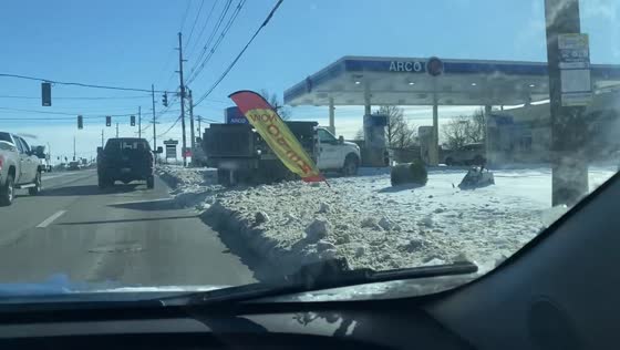 Vehicles navigate deep, uncleared snow after winter storm in Frankfort, Kentucky, USA