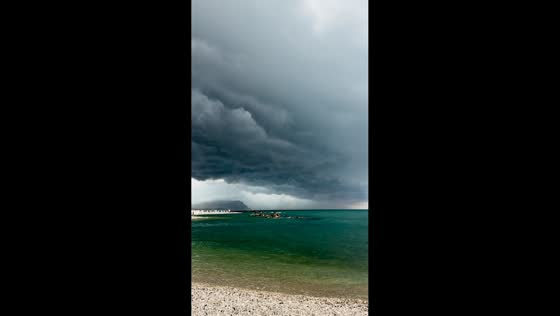 Ominous storm front sweeps toward coastline in Porto Recanati, Italy