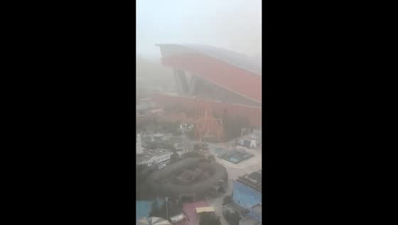 Roller coaster stalls mid-air during severe dust storm at Harbin amusement park in China