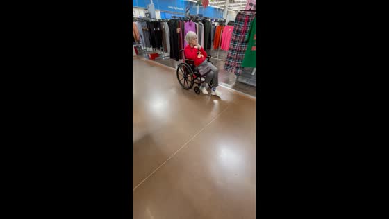 Old lady walks while riding a wheelchair in North Carolina, USA