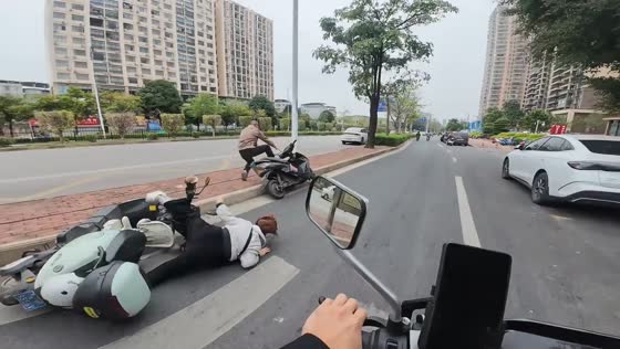 Motorcycle collision sends woman to the ground in Guangxi, China