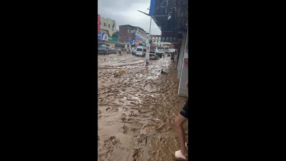 Mud covers roadway and vehicles after severe flood in Fujian, China