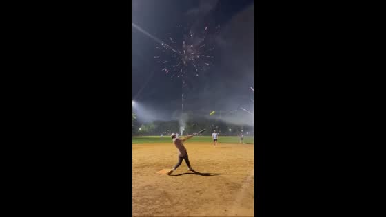 Baseball swing perfectly timed with fireworks burst in Chicago, Illinois, USA